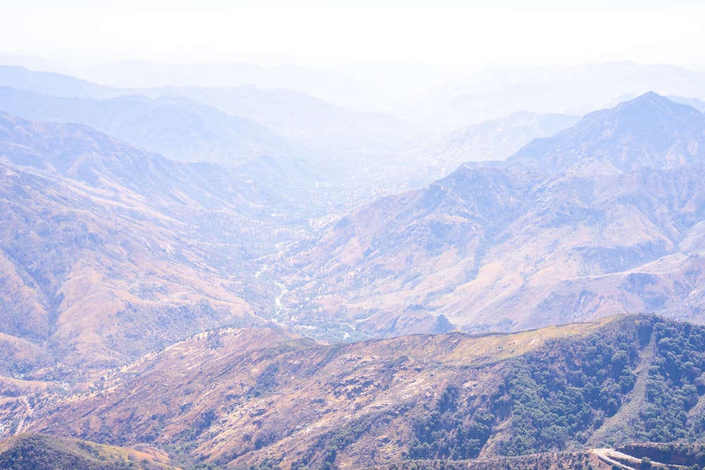 a view of a valley with mountains in the background