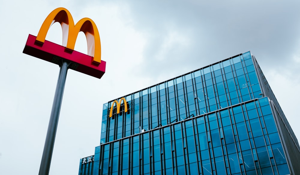 a large mcdonald's sign next to a tall building