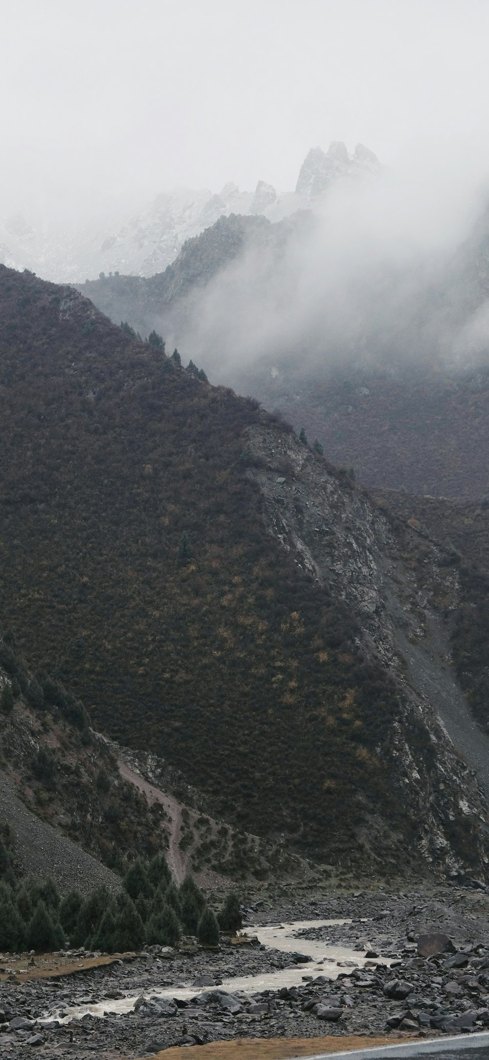 a view of a mountain range with a river in the foreground