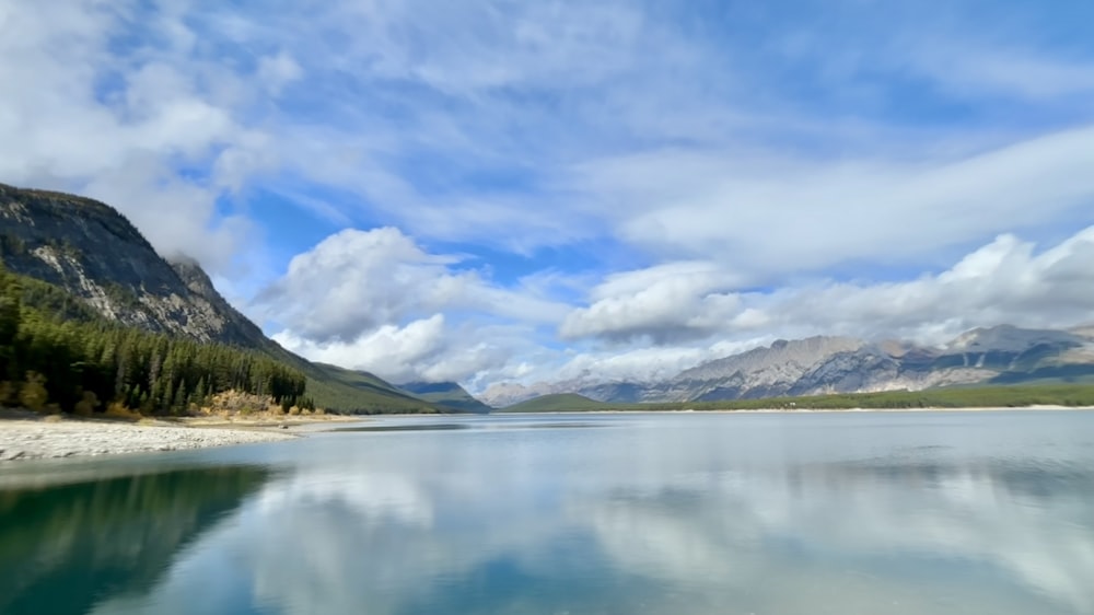 a body of water surrounded by mountains and trees