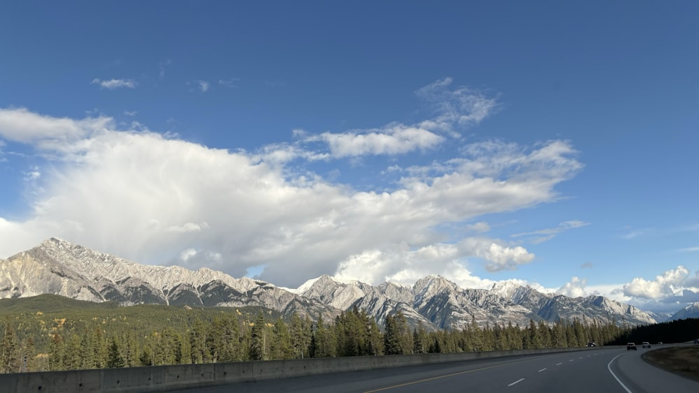 a highway with a mountain range in the background