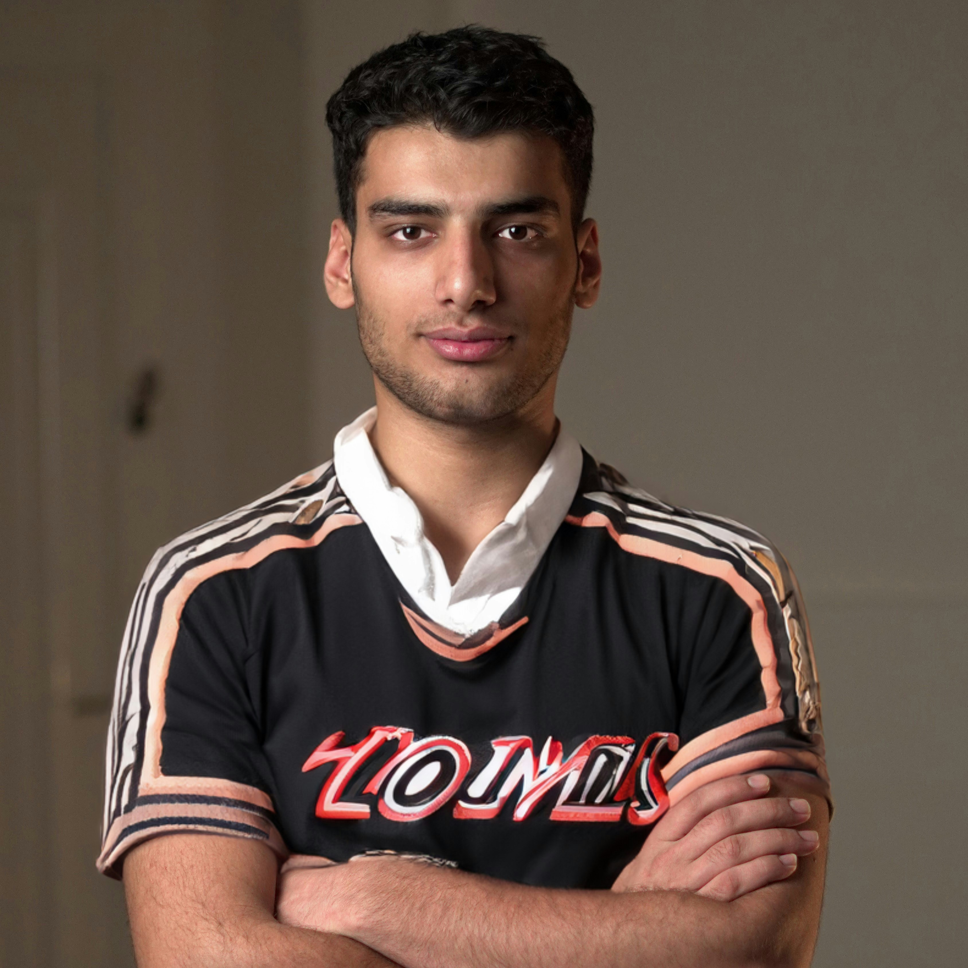 a man with his arms crossed posing for a picture