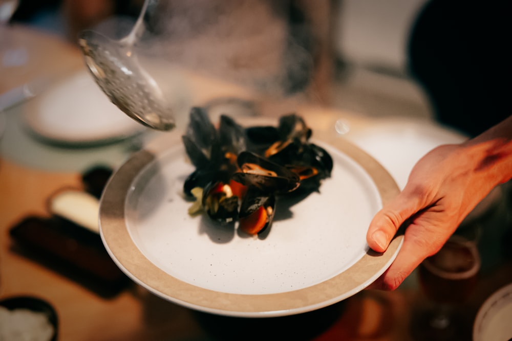a plate of mussels being served on a table