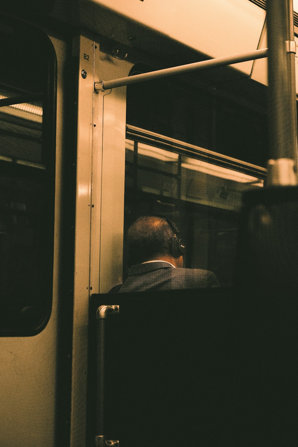 a man sitting on a train looking out the window