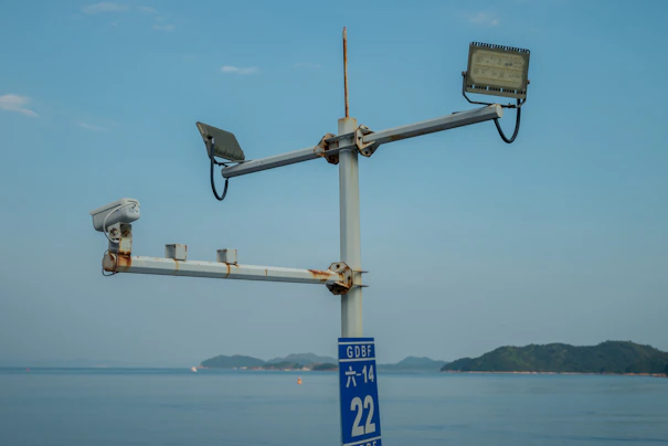 a couple of cameras on top of a metal pole