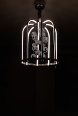 A beautifully designed chandelier illuminating a modern dining room.