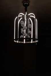 A sleek modern chandelier hanging above a dining table.