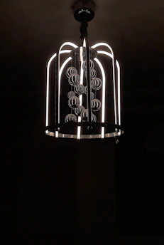 A sleek modern chandelier hanging above a dining table.