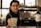 A bartender offering a cocktail in a glass with a Havana Club logo, accompanied by a bottle of Frontera Cabernet Sauvignon on the counter, with a blurred background.