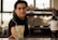 A bartender offering a cocktail in a glass with a Havana Club logo, accompanied by a bottle of Frontera Cabernet Sauvignon on the counter, with a blurred background.
