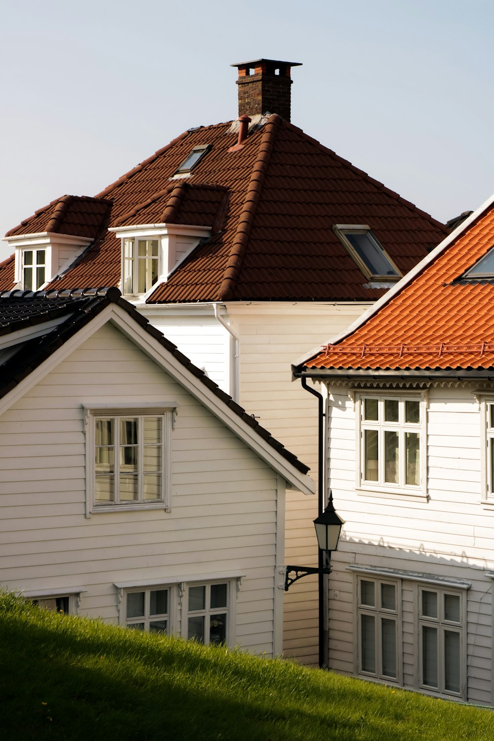 a row of white houses with a red roof