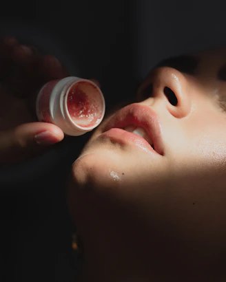 a woman is getting her face cream applied