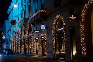 An elegant street scene in a luxury district, featuring upscale boutiques and softly lit sidewalks under dark red hues.