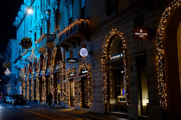 An elegant street scene in a luxury district, featuring upscale boutiques and softly lit sidewalks under dark red hues.