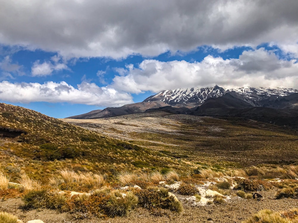 a mountain range with snow capped mountains in the distance