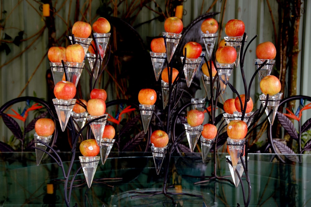 a glass table topped with lots of apples