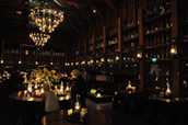 A refined cocktail reception with guests enjoying intimate conversation under warm lighting.