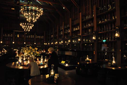 A refined cocktail reception with guests enjoying intimate conversation under warm lighting.