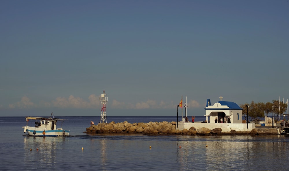 two boats are in the water near a pier