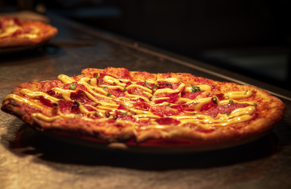 a pizza sitting on top of a pan covered in cheese