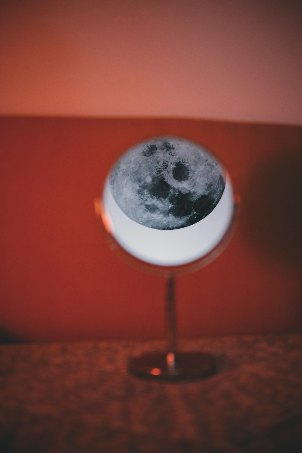 a small table with a lamp that has a picture of the moon on it