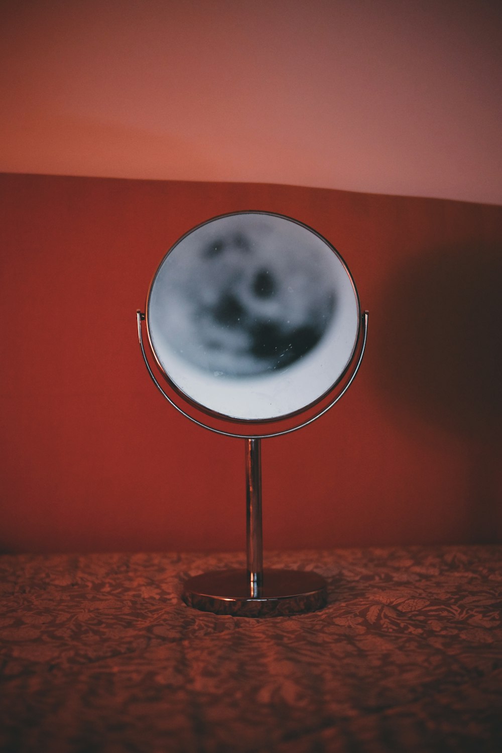 a mirror on a stand on a table