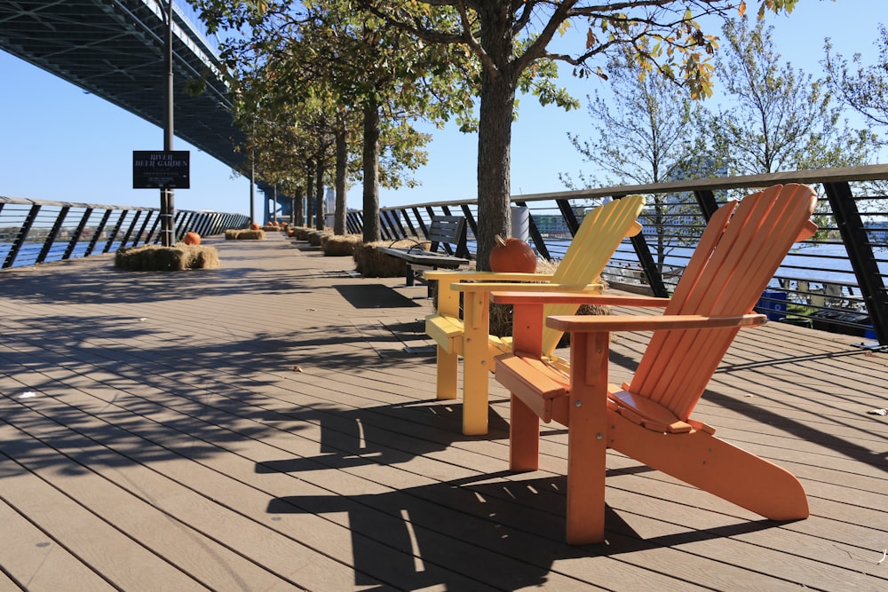 a couple of chairs sitting on top of a wooden deck