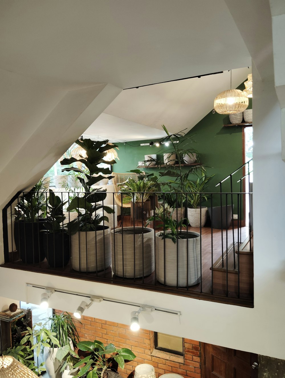 a view of a balcony with potted plants