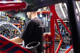 A craftsman carefully assembling a custom bicycle frame in a cozy workshop filled with wooden tools and bike parts.