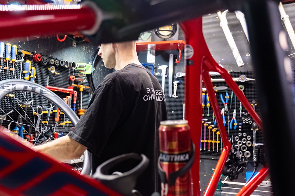 a man working on a bike in a garage