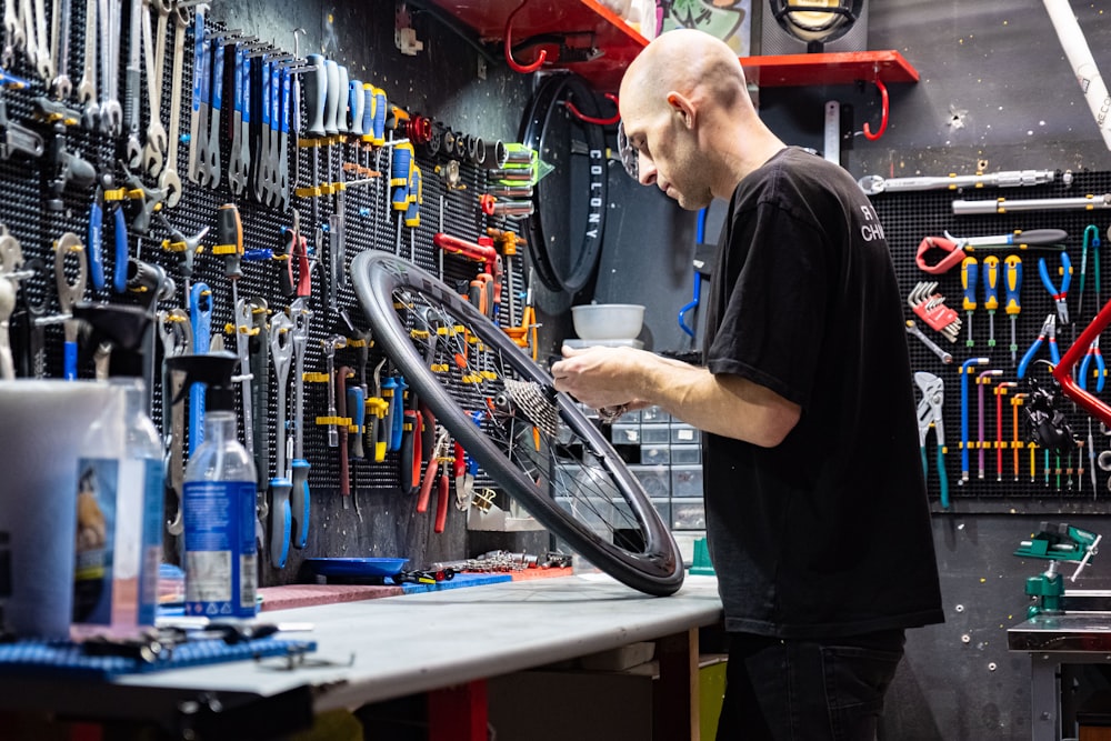 a man working on a bicycle in a shop