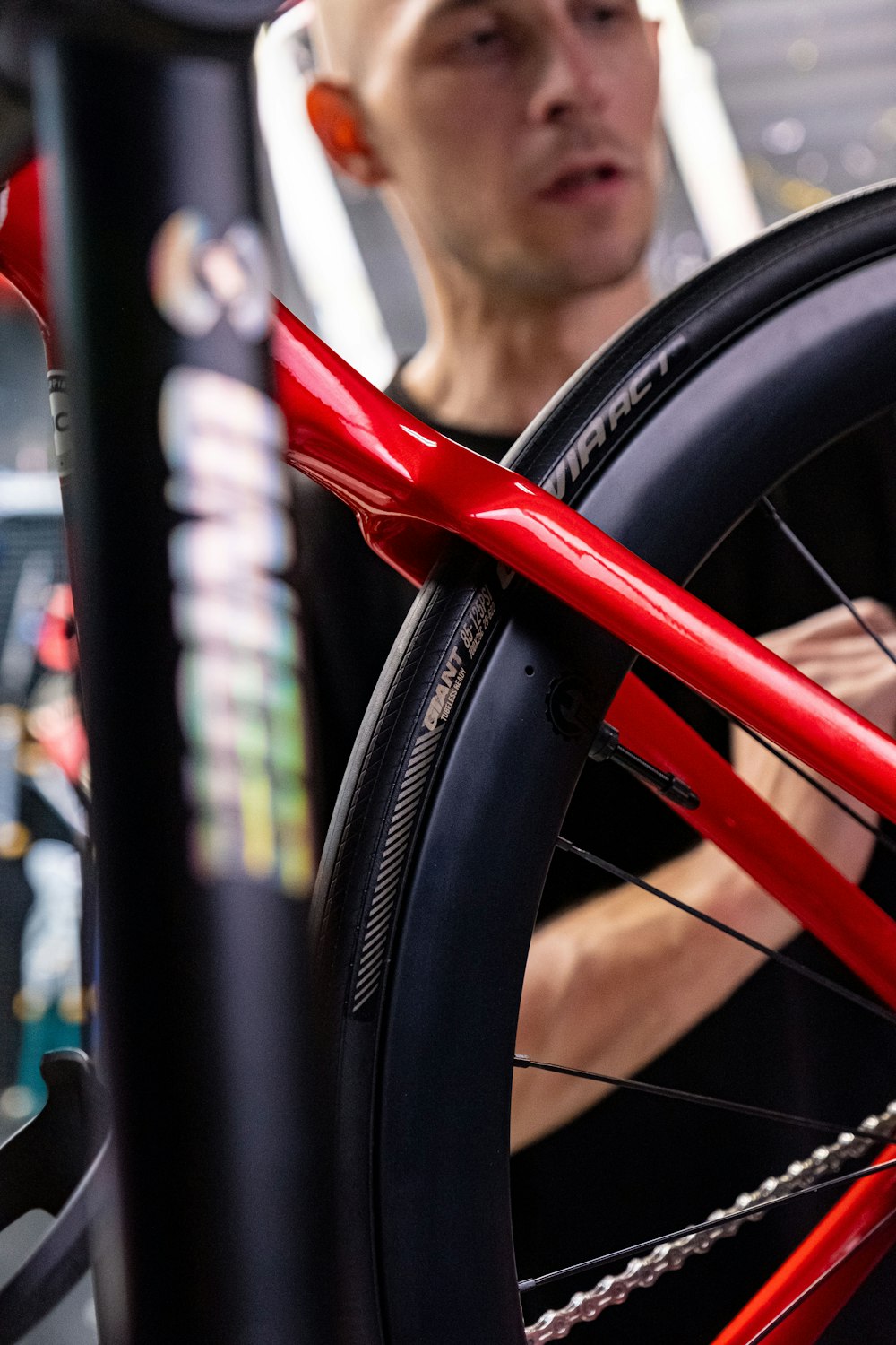 a man working on a bicycle wheel with a wrench