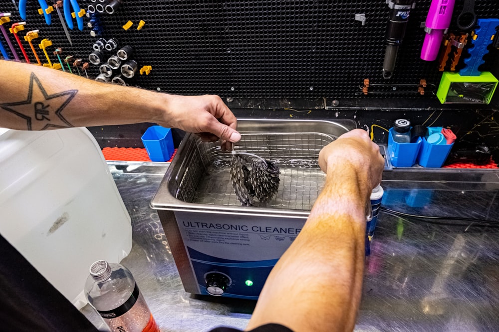 a man with a tattoo on his arm is washing his legs