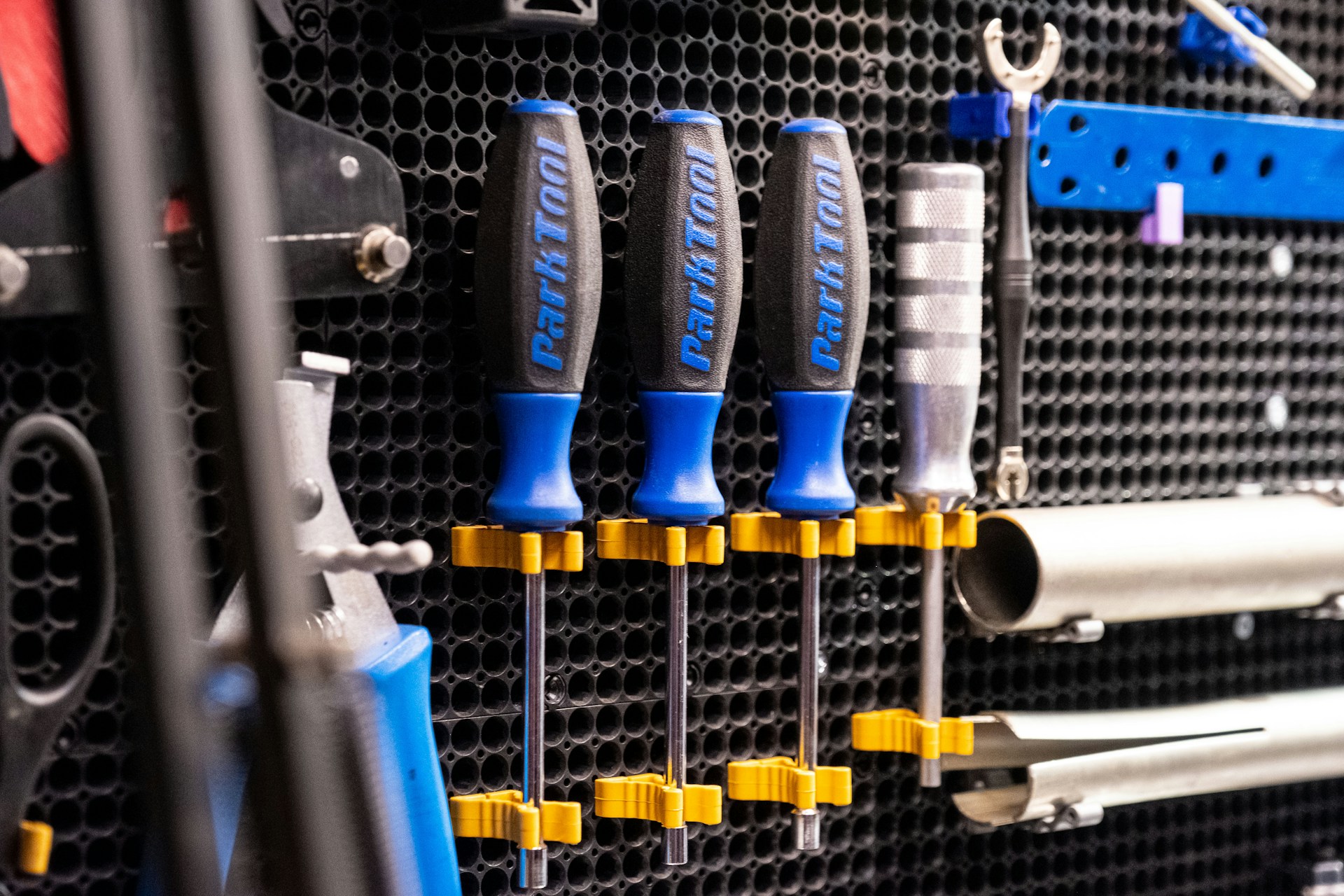 a bunch of tools hanging on a wall