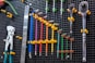a bunch of tools are hanging on a wall