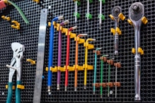 a bunch of tools are hanging on a wall