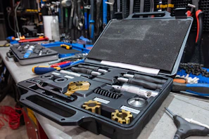 Bright yellow toolbox open with various tools ready for appliance repair