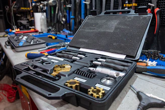 A sturdy toolbox filled with professional-grade construction tools arranged neatly on a wooden workbench.