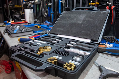 A sturdy toolbox filled with professional-grade construction tools arranged neatly on a wooden workbench.