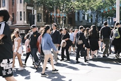 a crowd of people walking across a street