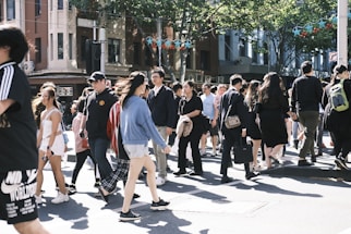 a crowd of people walking across a street