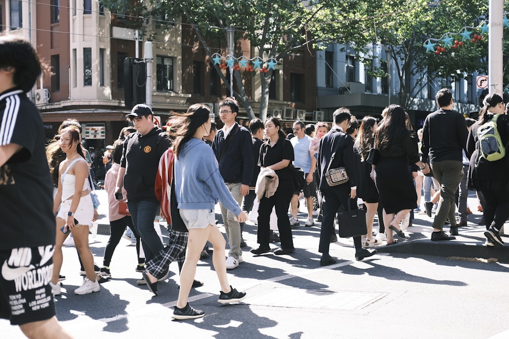 a crowd of people walking across a street