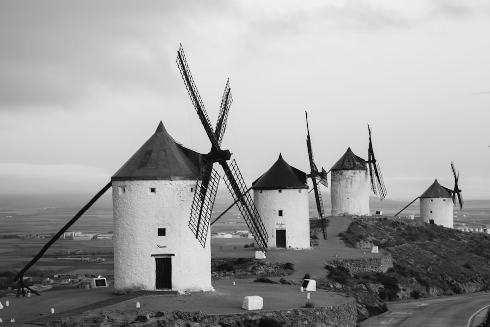 a black and white photo of a row of windmills