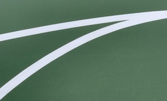 A close-up of a precision-cut stencil on a basketball court.