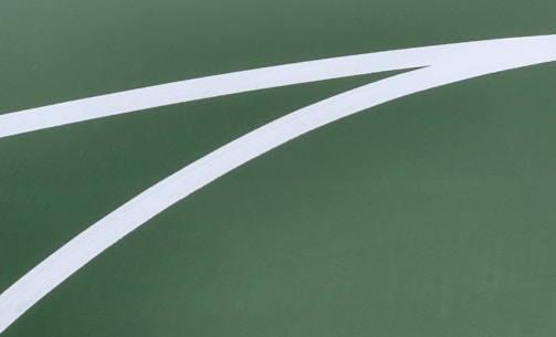 A close-up of a precision-cut stencil on a basketball court.