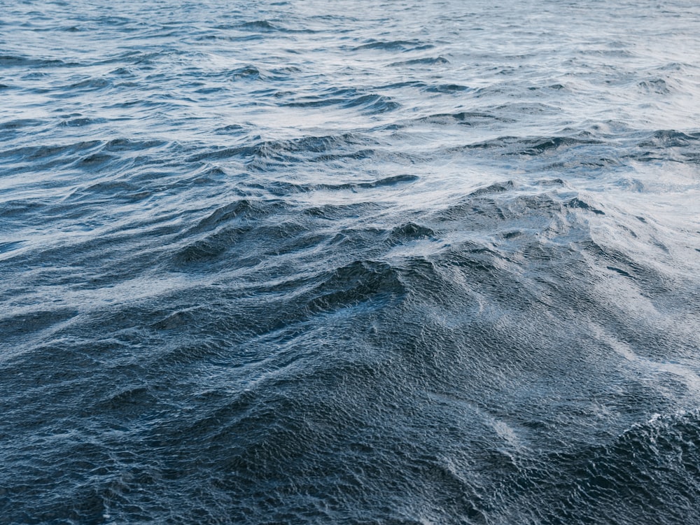 a large body of water with a boat in the distance