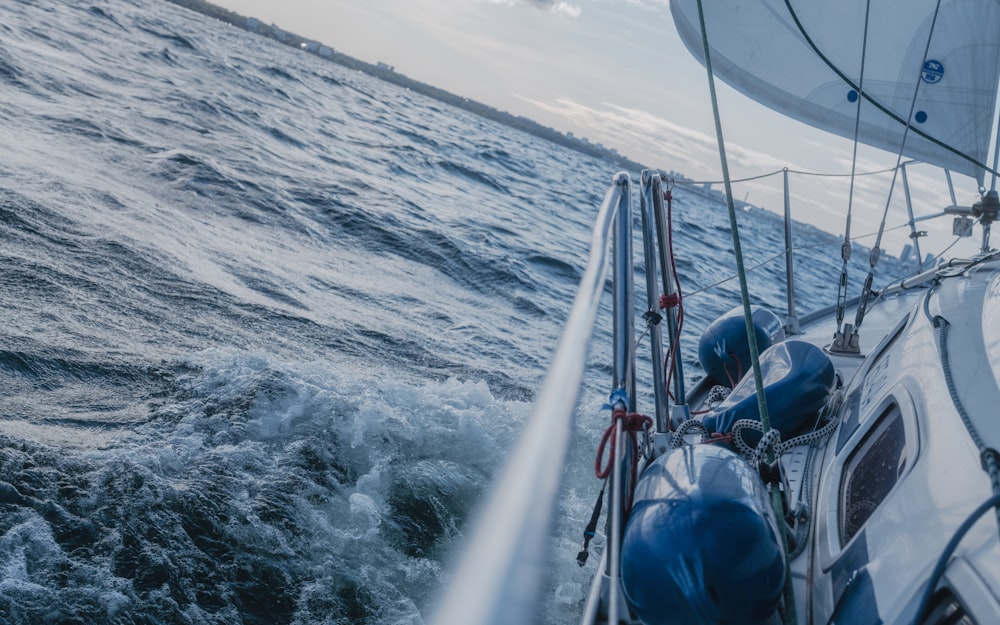 a sailboat sailing through the ocean on a sunny day