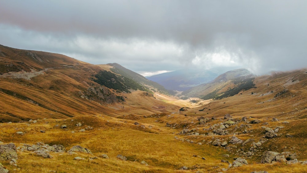 a view of a valley with mountains in the background