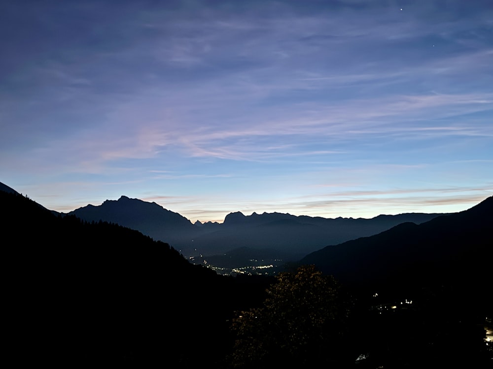 a view of a mountain range at dusk