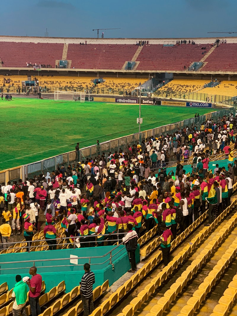 A large crowd of football supporters in an African stadium